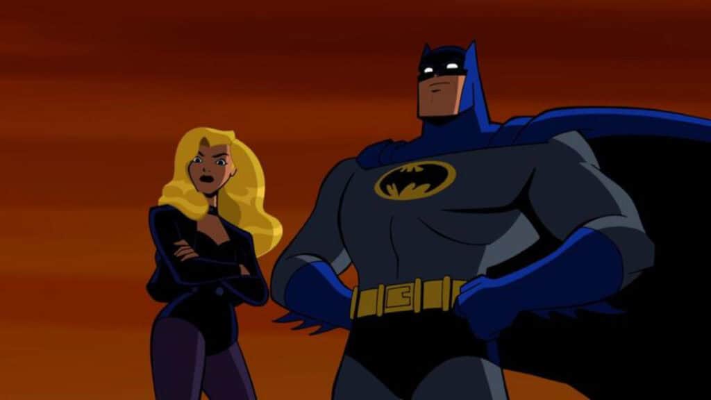 Batman poses with his hands on his hips beside Black Canary in The Brave and the Bold