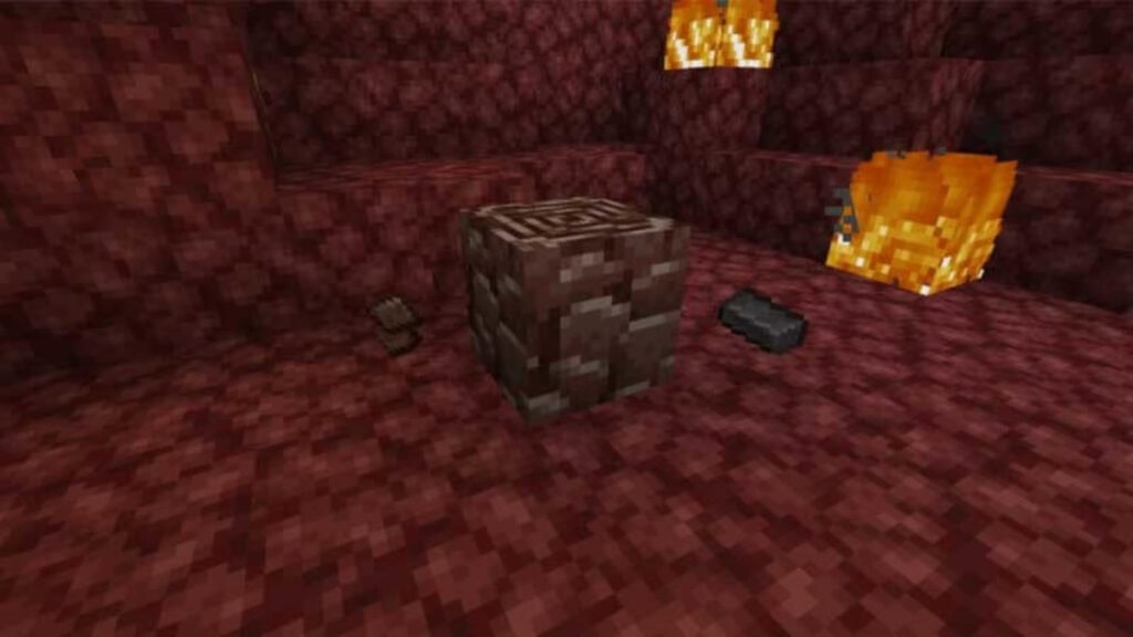 A block of Ancient Debris containing Netherite in a lava cave in Minecraft