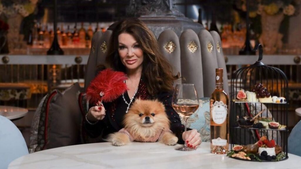 Pump Rules Lisa Vanderpump poses in a restaurant