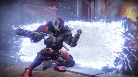 A Guardian takes shelter behind a crumbling energy shield in Destiny 2 by Bungie