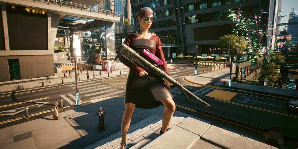 V poses in Night City with her sniper rifle in Cyberpunk 2077