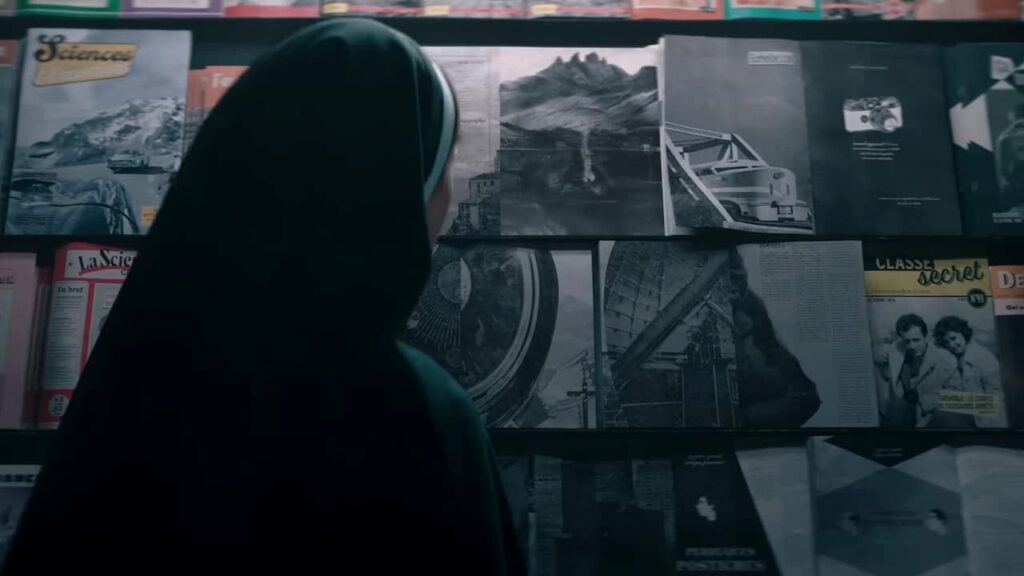 Sister Irene looking at Valak through magazines in The Nun II