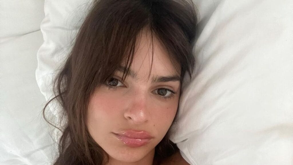 Emily Ratajkowski posing nude in bed