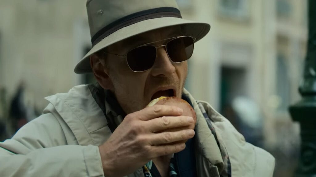 Michael Fassbender eating a burger in David Fincher's The Killer.