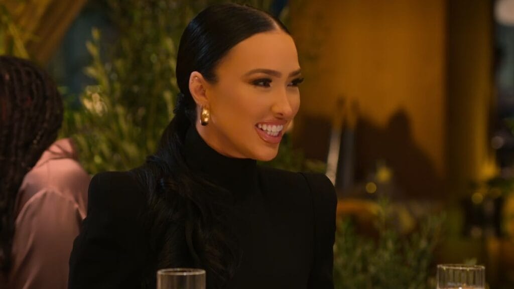 Bre Tiesi smiling at dinner on season 7 of Selling Sunset.