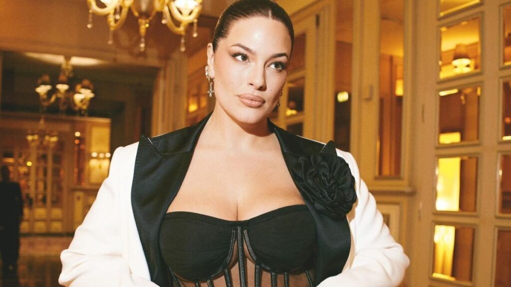 Ashley Graham poses in jumpsuit and jacket