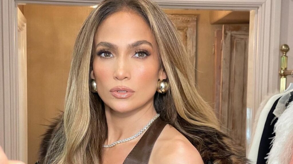 Jennifer Lopez in a brown fur coat and tank top.