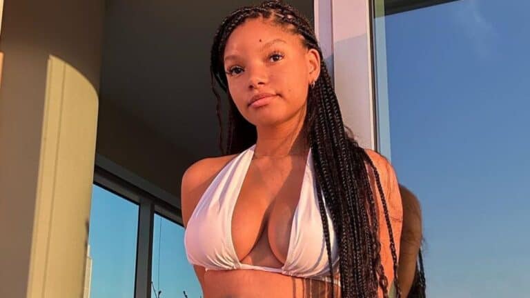 Halle Bailey, 24, in white swimwear.