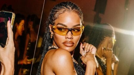 Photo of Teyana Taylor in sheer top and sunglasses.