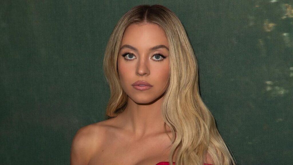 Sydney Sweeney busty display in red tube dress.