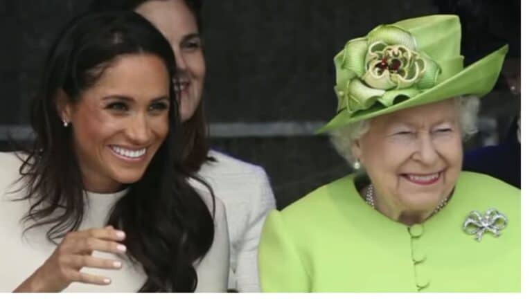 Meghan Markle and Queen Elizabeth smile during a royal engagement.