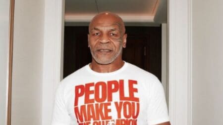 Mike Tyson poses in champion shirt