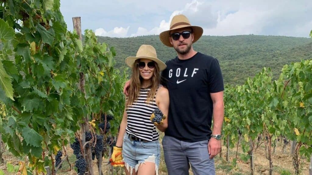 Jessica Biel and Justin Timberlake pose on a farm while wearing sunglasses