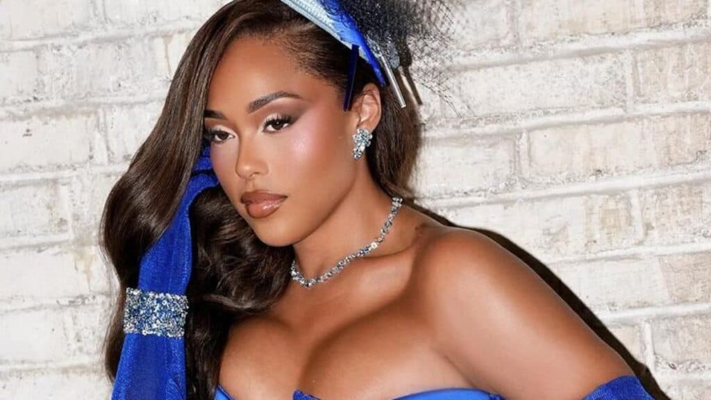 Jordyn Woods in a blue dress and gloves