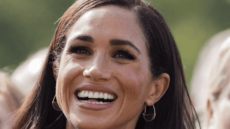 Meghan Markle Grinning with a Look of Pain