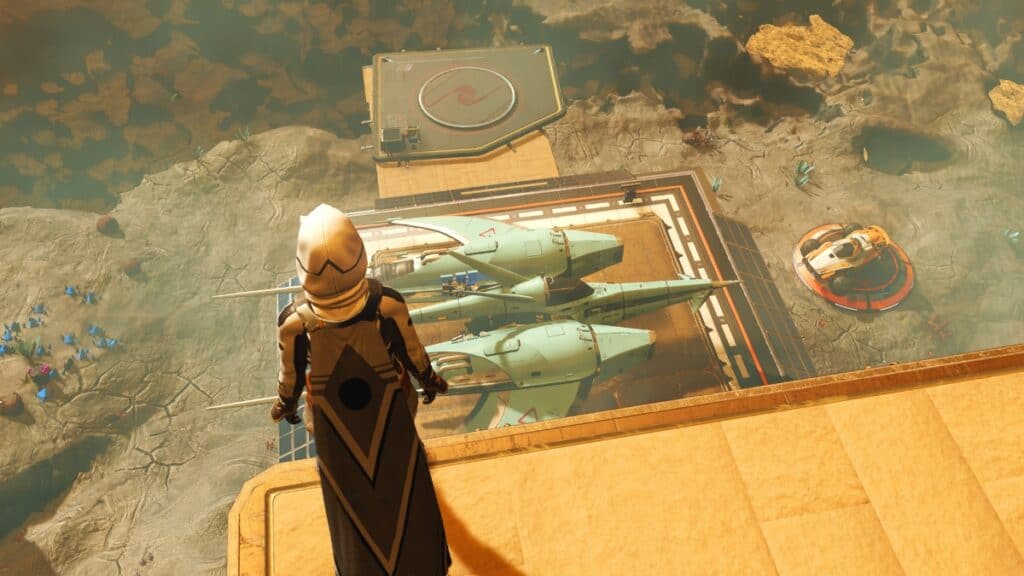 The player looks down upon a landing pad and their grounded solar ship