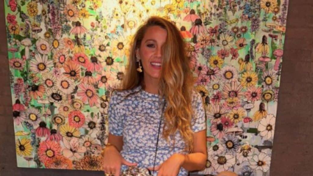 Blake Lively poses infront of flower background