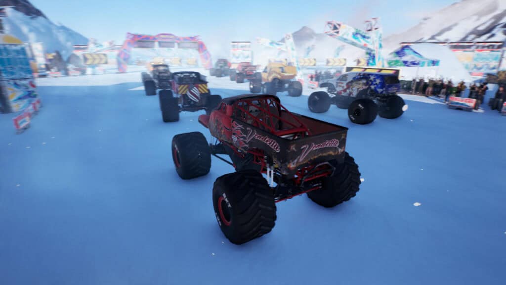 Trucks prepare to start a race on an icy track in Monster Jam Showdown