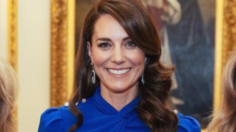 Kate Middleton posing in a blue dress.