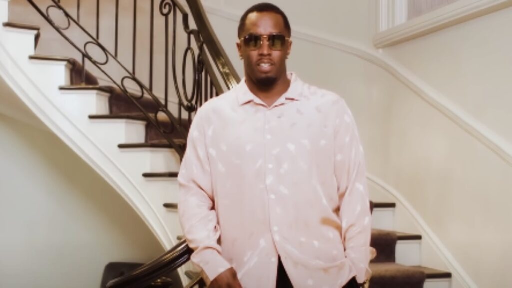 Sean Diddy Combs poses on the staircase in his LA mansion