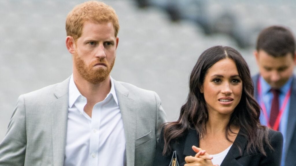 Prince Harry and Meghan Markle look distressed.