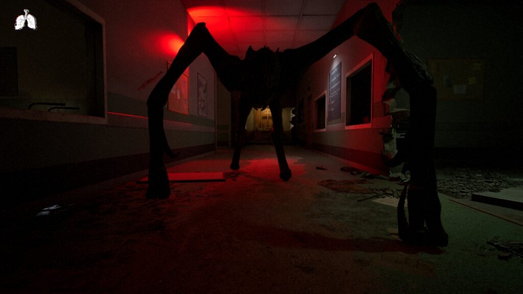 A creature looms over the player in a red-lit hallway