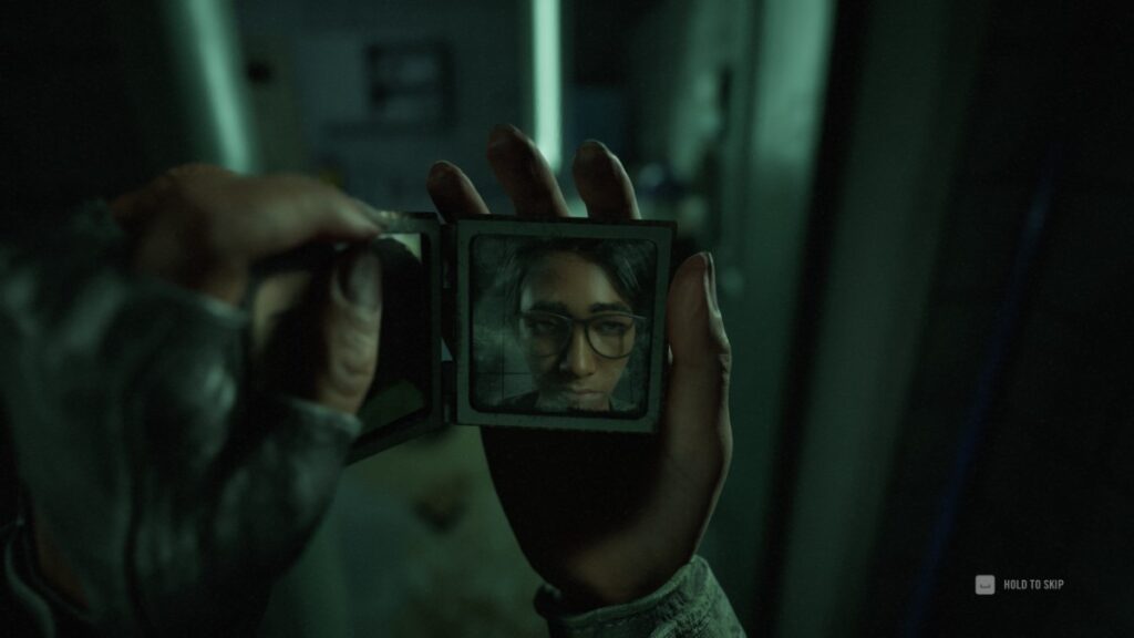 Alex studies herself in a small mirror in A Quiet Place: The Road Ahead