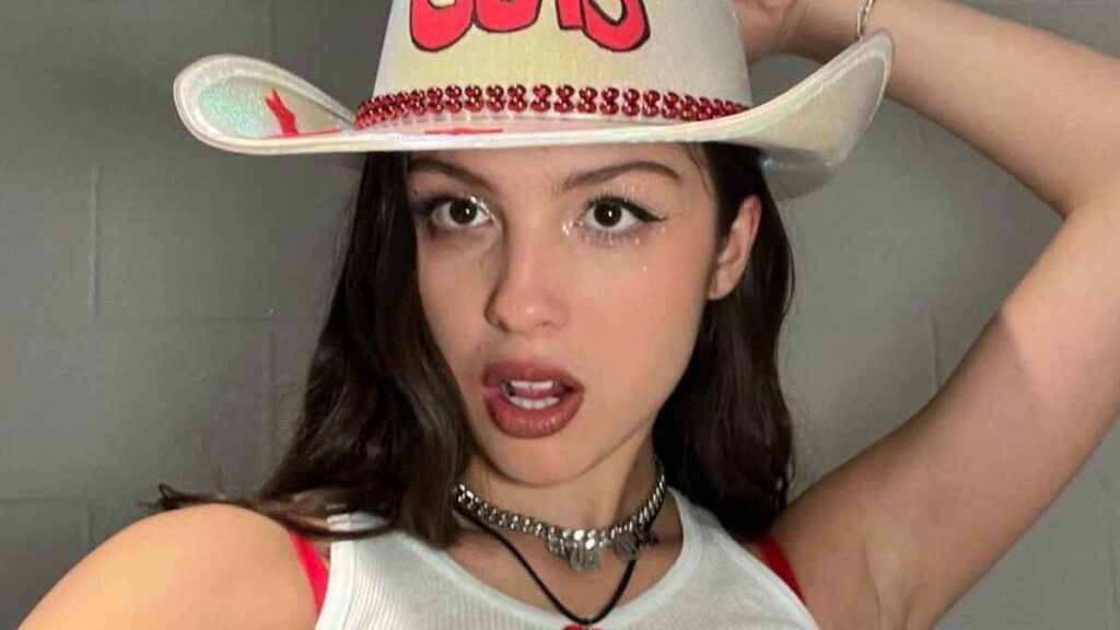 Olivia Rodrigo wearing a "Guts" world tour hat