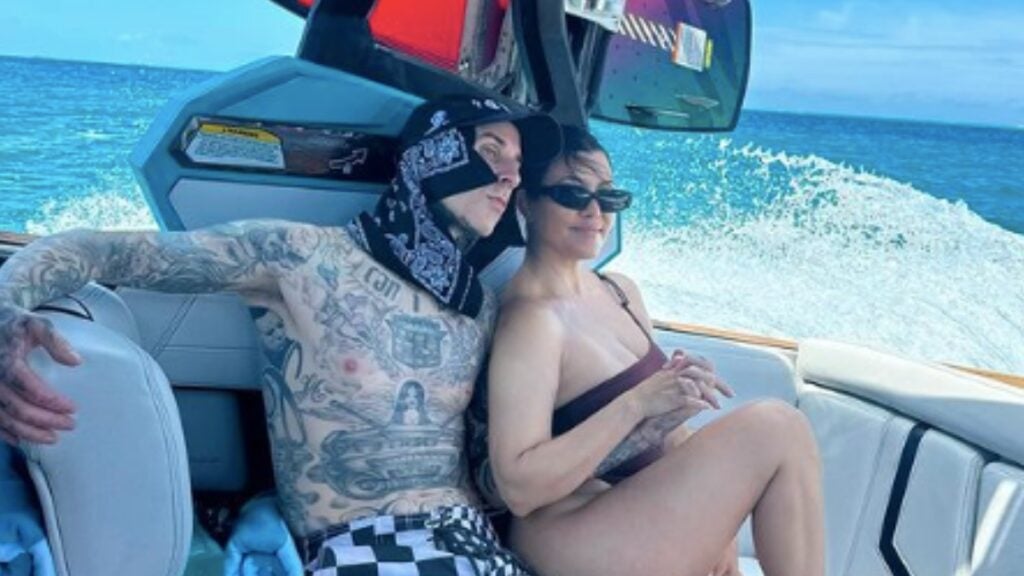 Travis Barker and Kourtney Kardashian pose on a boat