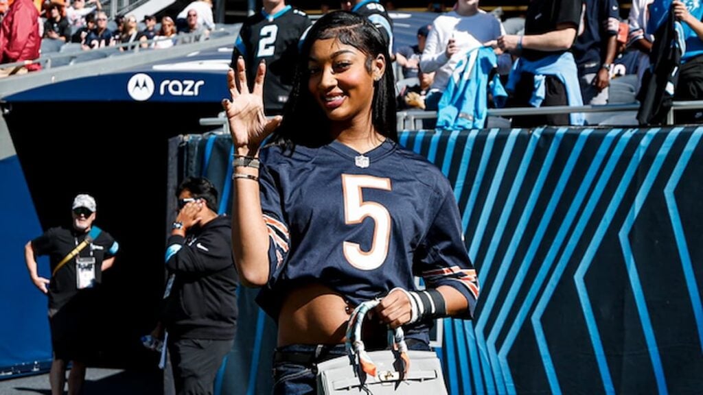 Angel Reese posing inside the Chicago Bears stadium.