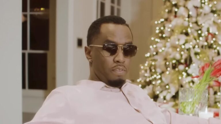 Sean "Diddy" Combs sitting on a couch looking into camera.