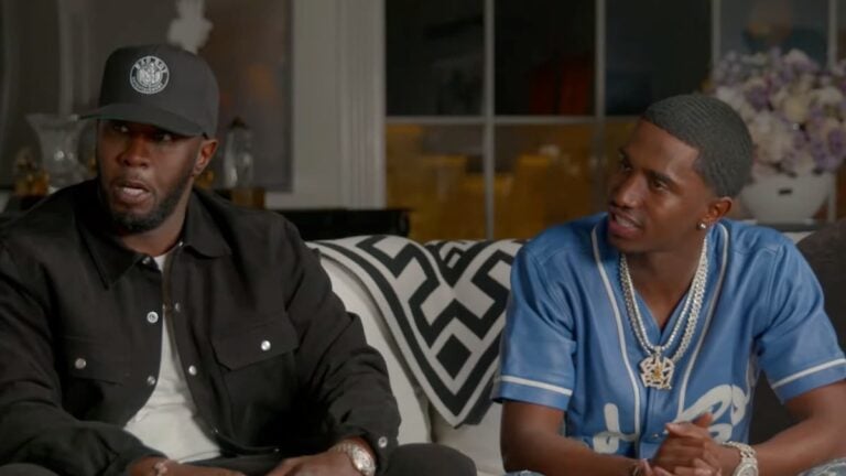 Diddy sitting on a couch with his son.