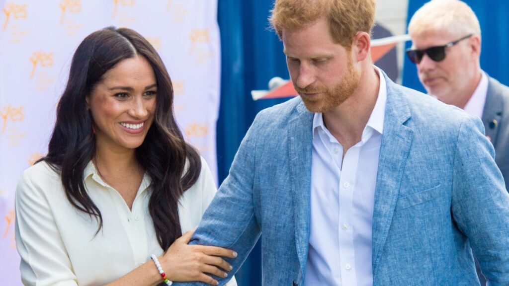 Meghan Markle smiles alongside Prince Harry