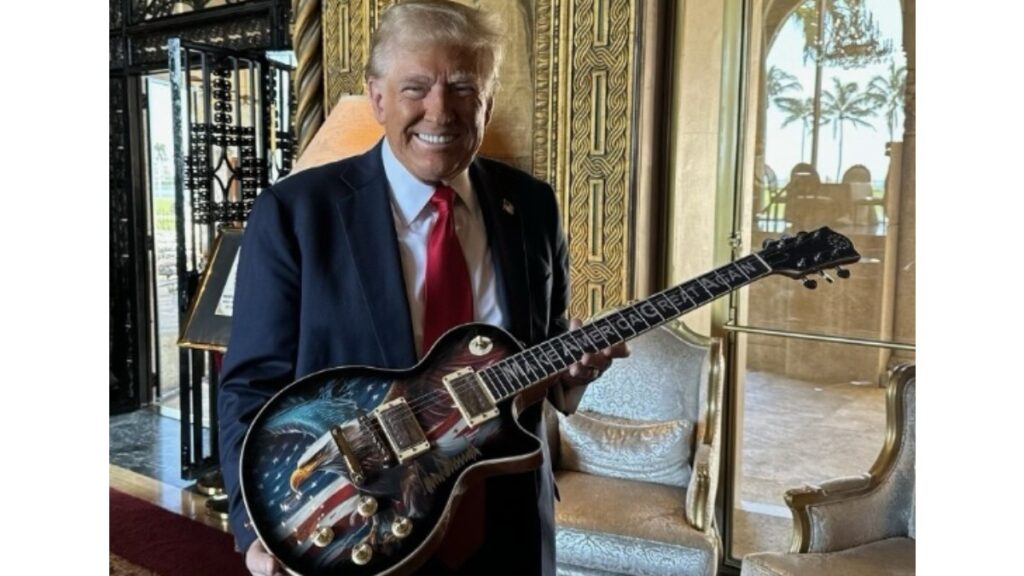 Donald Trump holding an emblazoned limited edition Trump Guitar.