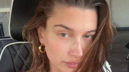 New mom Hailey Bieber poses in her car for post-baby Summer snaps.