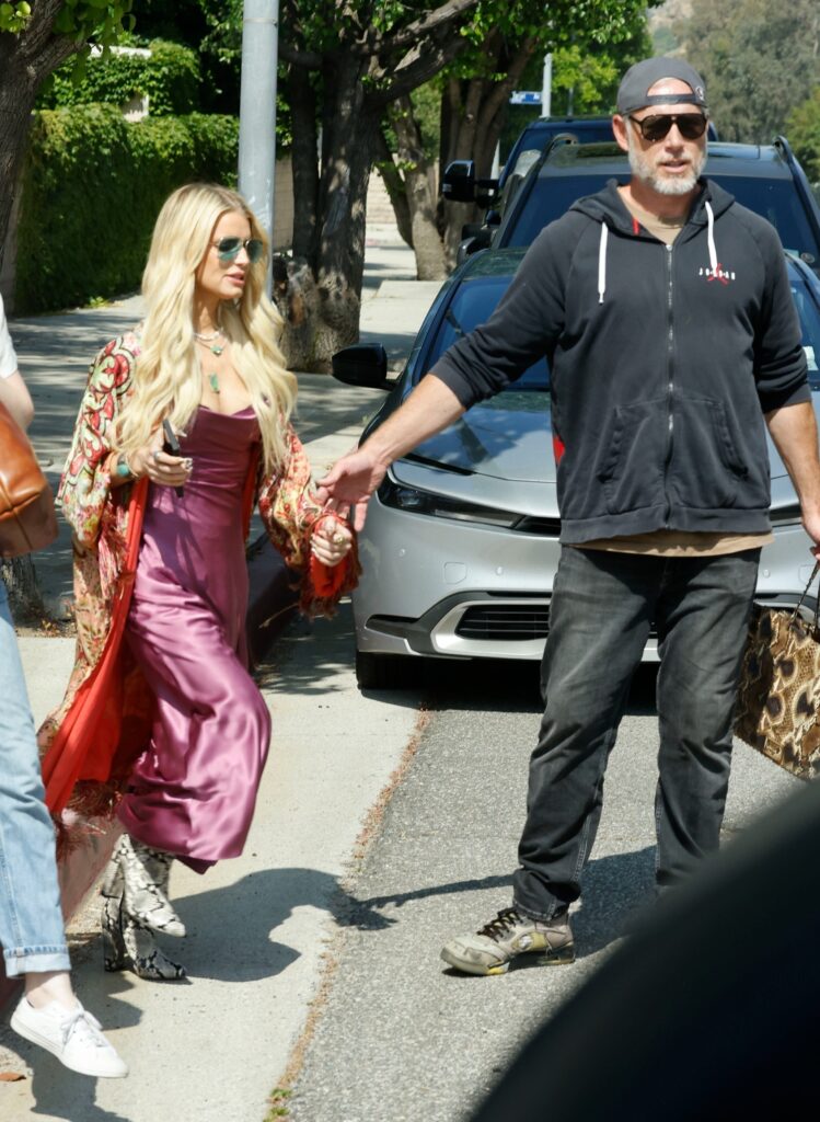 Jessica Simpson wears a silk dress with a thigh-high slit to her daughter Birdie's graduation, accompanied by her family and husband Eric Johnson.