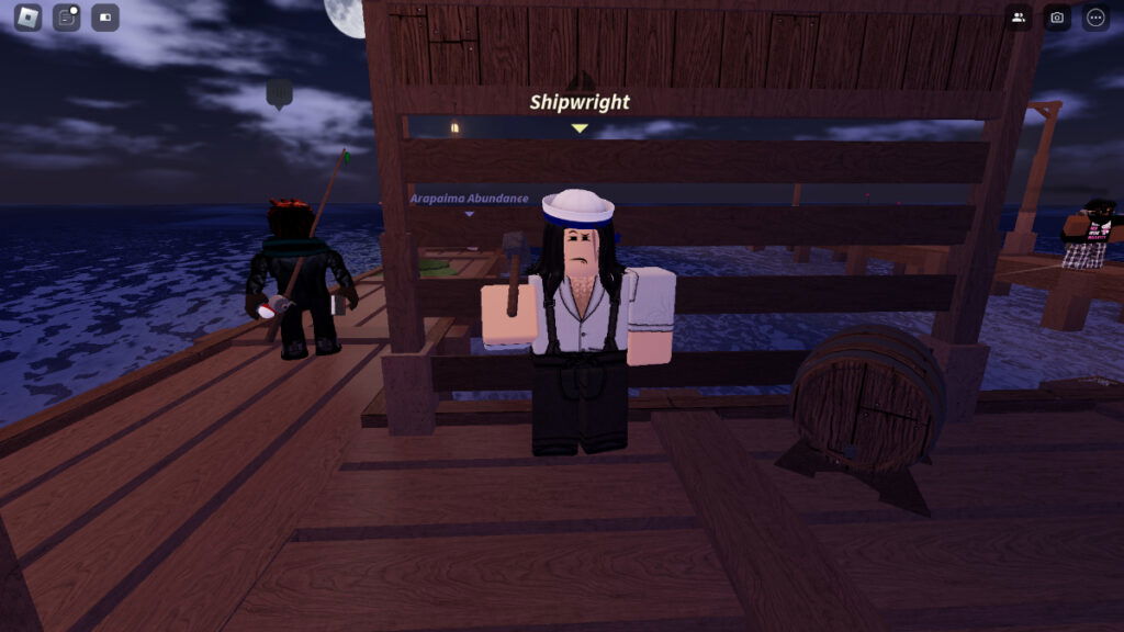 A shipwright stands on the dock in Fisch