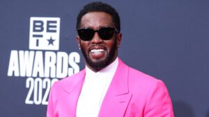 Diddy wearing a pink suit.