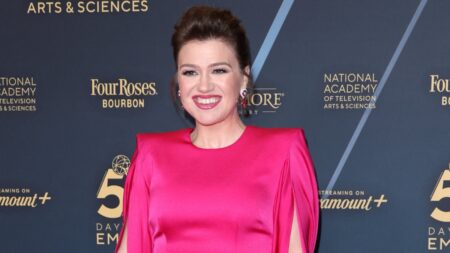 Kelly Clarkson smiles in pink dress