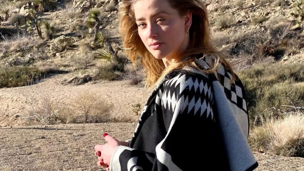 Amber Head in a hill-like place wearing a black and white coverall