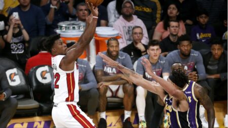 Jimmy Butler shoots over two Lakers defenders