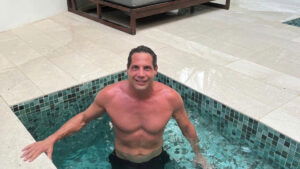 Joe Francis standing in a shallow pool