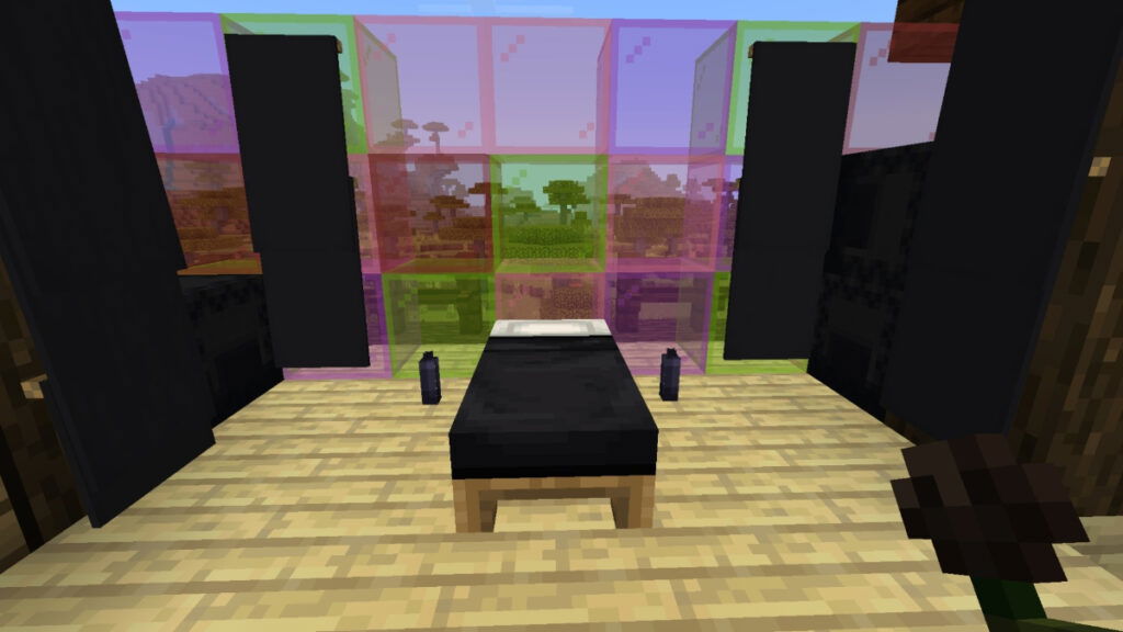 A bedroom featuring black dye items and stained glass in Minecraft