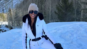 Nia Long in a white jumpsuit on a snowy field