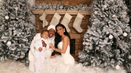 A photo of Nick Cannon, Bre Tiesi and their son wearing all white for a Christmas photo