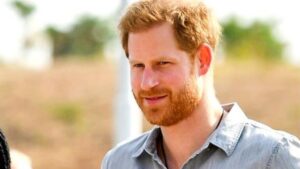 Prince Harry wearing a blue shirt.