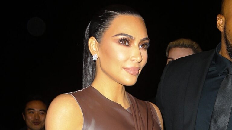 Kim Kardashian wears brown leather dress