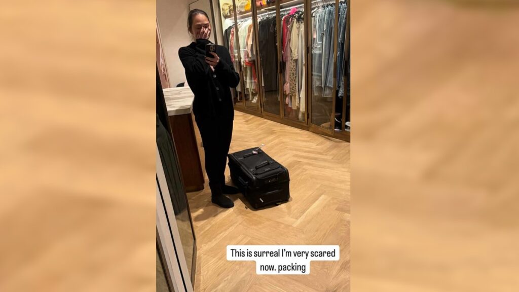 Chrissy Teigen shares selfie on Instagram stories before evacuating LA home due to spreading wildfires.