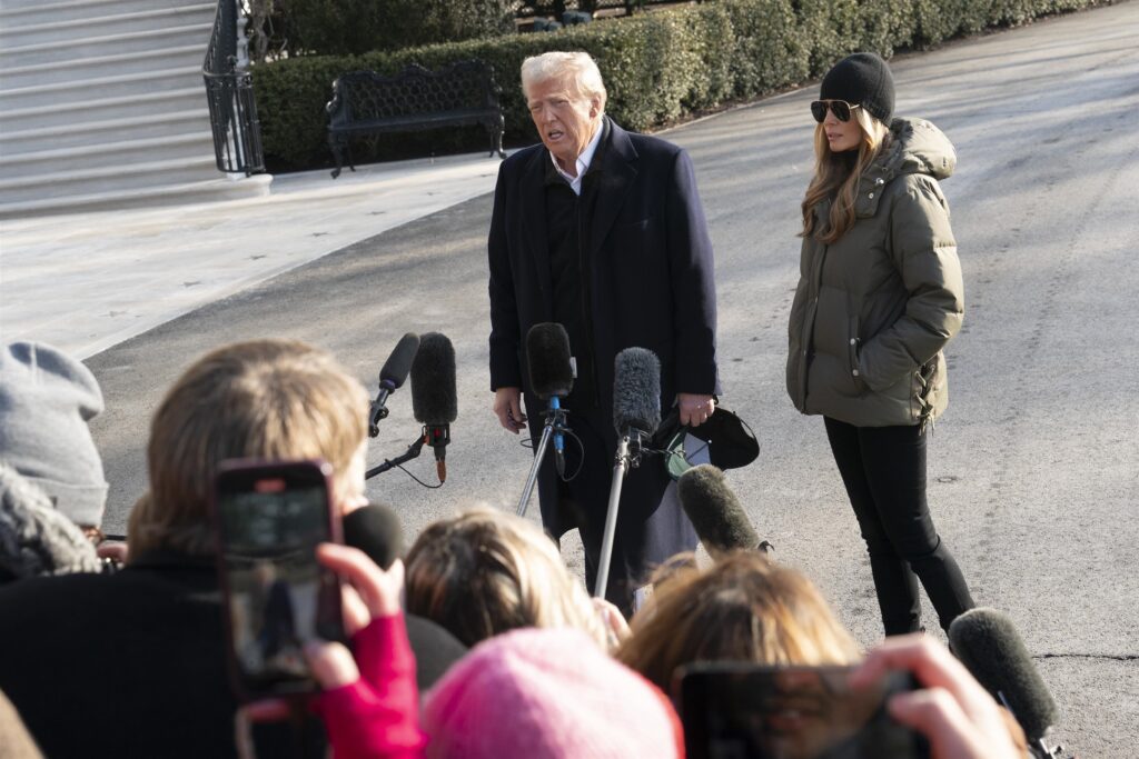 United States President Donald Trump addresses the media alongside First Lady Melania Trump before departing the White House. The pair embarks on a multi-day trip with stops in Asheville, Santa Monica, Las Vegas, and Miami.