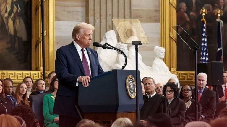 Donald Trump stands at a podium, speaking to a crowd